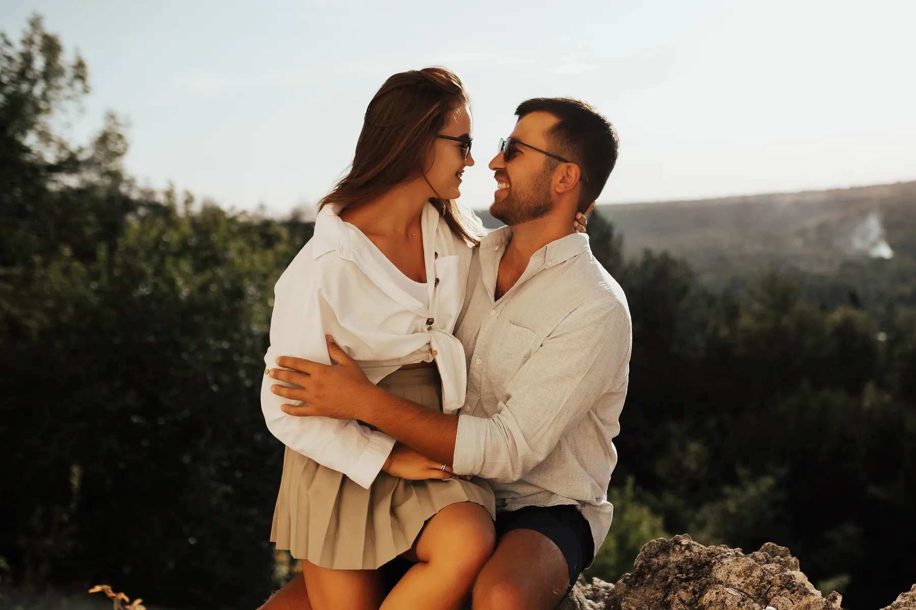 A couple sharing a quiet moment outdoors at sunset